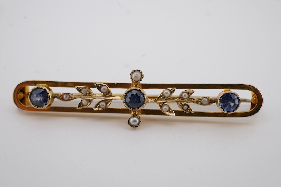 An Edwardian 9ct, sapphire and seed pearl set bar brooch, 43mm, gross weight 2.6 grams, together with a similar 15ct and seed pearl cluster set bar brooch, gross weight 2.9 grams. Condition - fair to good